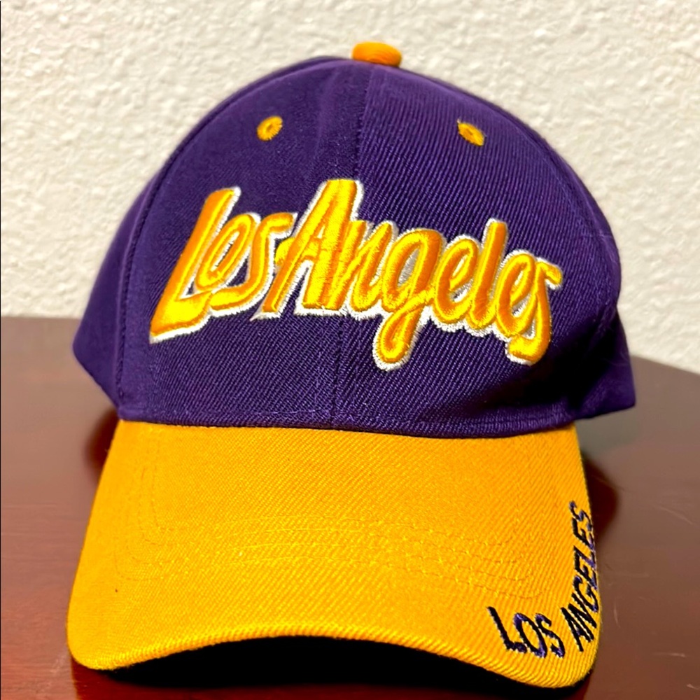LA LAKERS AMERICAN NEEDLE PURPLE/ GOLD CAP STRAPBACK W/ LOS ANGELES ON THE BACK. - Picture 1 of 5